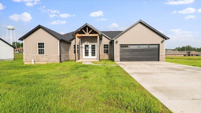 2605 Country Dr, Mountain Grove, MO 65711 - view of front facade with french doors, stone siding, a front yard, and a garage