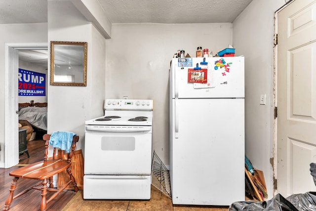 1673 E Chestnut St, Springfield, MO 65802 - kitchen featuring white appliances and a textured ceiling