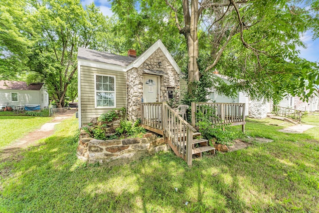 1673 E Chestnut St, Springfield, MO 65802 - view of front of home featuring a chimney, a front lawn, and stone siding
