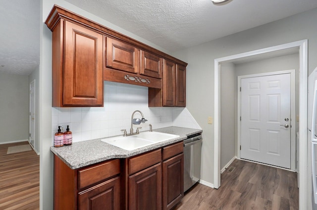 2606 S Overbrook Ave, Springfield, MO 65807 - kitchen with dishwasher, dark wood-style floors, a textured ceiling, decorative backsplash, and light countertops