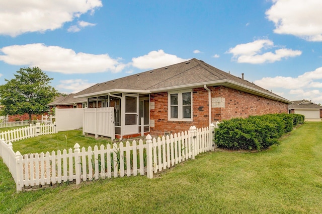2606 S Overbrook Ave, Springfield, MO 65807 - back of house with a sunroom, brick siding, roof with shingles, and a fenced backyard