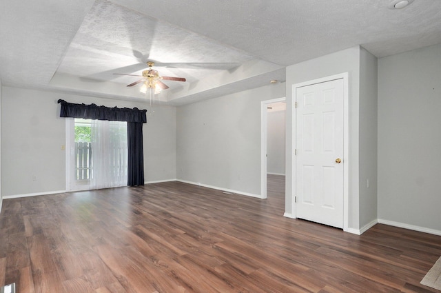 2606 S Overbrook Ave, Springfield, MO 65807 - empty room featuring a raised ceiling, wood finished floors, ceiling fan, and a textured ceiling