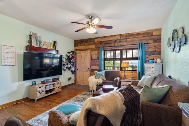 6089 State Highway Dd Unit 103, Branson West, MO 65737 - living area with wooden walls, a ceiling fan, and wood finished floors