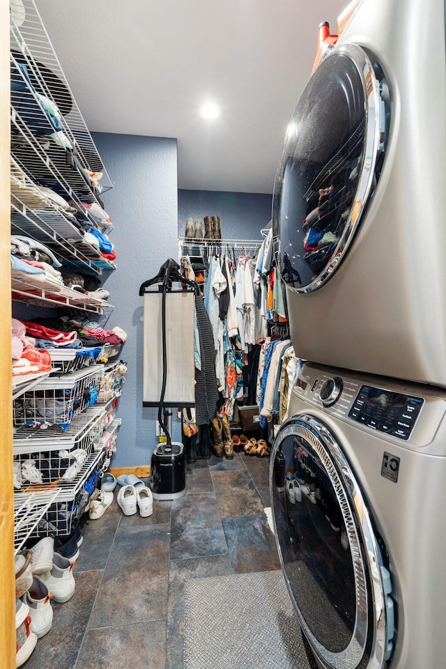 6089 State Highway Dd Unit 103, Branson West, MO 65737 - laundry area with stacked washer and clothes dryer and stone finish floors