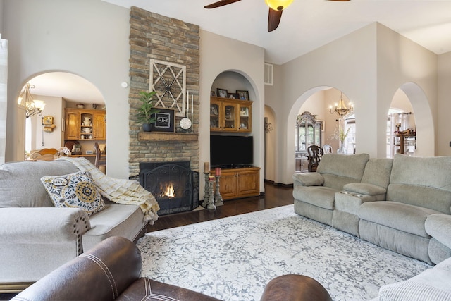 417 Panorama Dr, Cape Fair, MO 65624 - living room with arched walkways, dark wood-style floors, a chandelier, a high ceiling, and ceiling fan