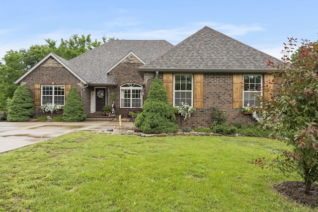 417 Panorama Dr, Cape Fair, MO 65624 - view of front of home featuring a shingled roof, brick siding, and a front lawn