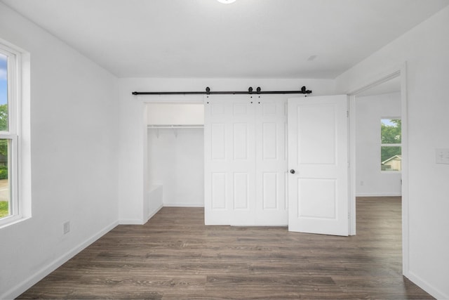 503 Valley View St, Carl Junction, MO 64834 - unfurnished bedroom with dark wood finished floors, a closet, and a barn door