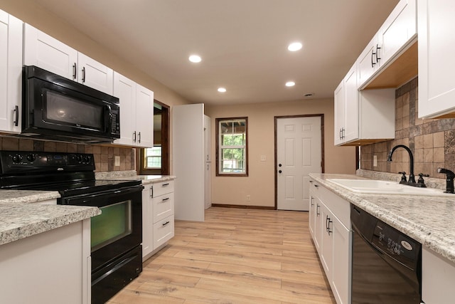 311 College St, Crane, MO 65633 - kitchen featuring black appliances, decorative backsplash, recessed lighting, light countertops, and white cabinets