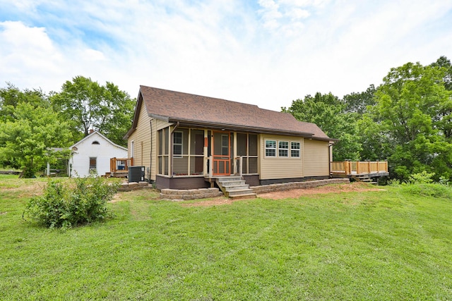311 College St, Crane, MO 65633 - view of front of home featuring a sunroom, a front lawn, a deck, and roof with shingles