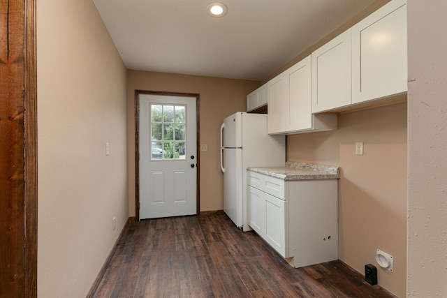 311 College St, Crane, MO 65633 - kitchen with freestanding refrigerator, dark wood-type flooring, white cabinetry, light countertops, and recessed lighting
