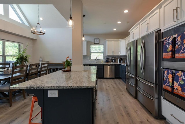 280 Lakefront Dr, Branson, MO 65616 - kitchen with appliances with stainless steel finishes, healthy amount of natural light, a chandelier, light wood finished floors, and recessed lighting