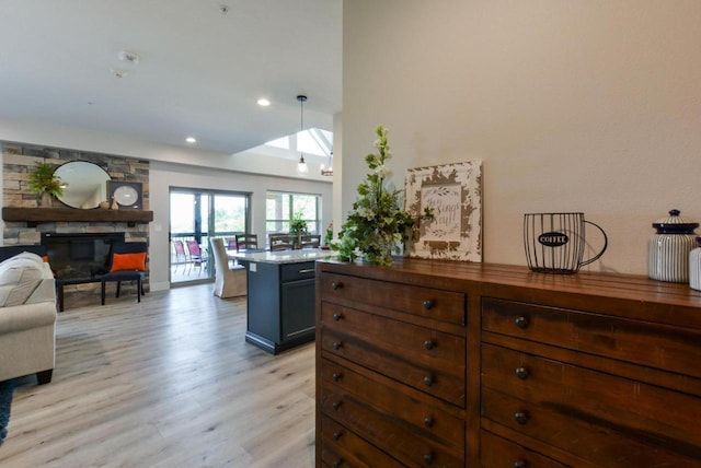 280 Lakefront Dr, Branson, MO 65616 - kitchen featuring light wood-type flooring, open floor plan, a fireplace, recessed lighting, and decorative light fixtures