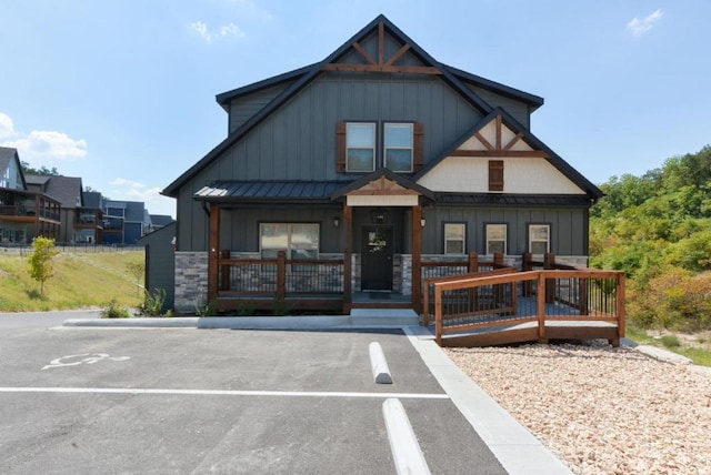 280 Lakefront Dr, Branson, MO 65616 - view of front facade with board and batten siding, a porch, and stone siding
