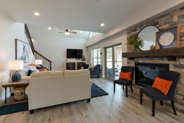 280 Lakefront Dr, Branson, MO 65616 - living room with light wood finished floors, a stone fireplace, a ceiling fan, stairs, and recessed lighting