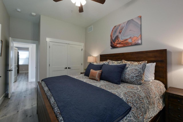280 Lakefront Dr, Branson, MO 65616 - bedroom with wood finished floors, a ceiling fan, and a closet
