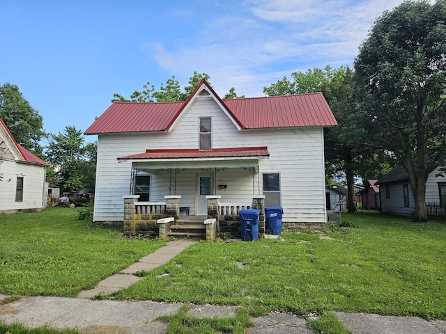 417 Wells St, Greenfield, MO 65661 - view of front of house with covered porch, a front lawn, and a metal roof