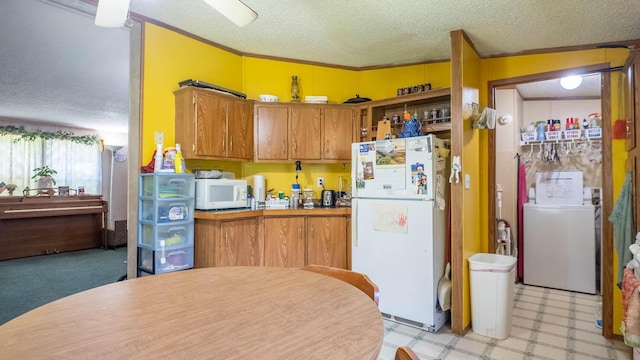 167 Timber Valley Rd, Mammoth Spring, AR 72554 - kitchen featuring white appliances, washer / clothes dryer, a textured ceiling, light flooring, and brown cabinetry