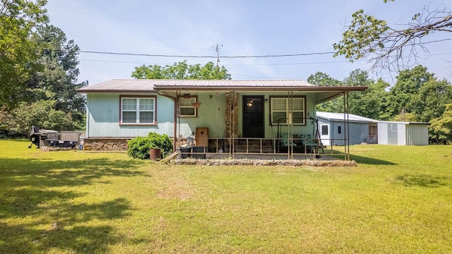 185 Timber Valley Rd, Mammoth Spring, AR 72554 - back of property with covered porch, a lawn, a metal roof, and an outdoor structure