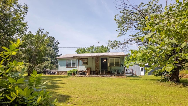 185 Timber Valley Rd, Mammoth Spring, AR 72554 - back of property featuring a porch, a lawn, and a metal roof