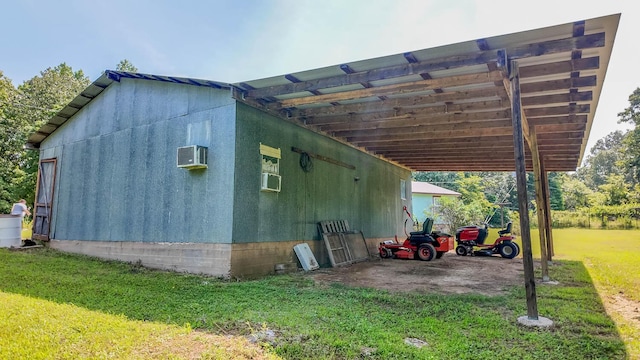 185 Timber Valley Rd, Mammoth Spring, AR 72554 - view of side of home with a carport, a lawn, and a wall mounted air conditioner