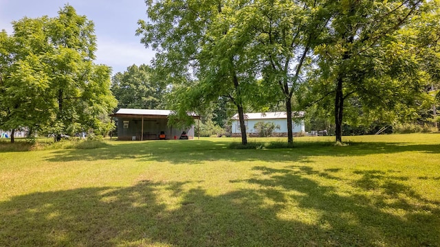 185 Timber Valley Rd, Mammoth Spring, AR 72554 - view of green lawn with a carport