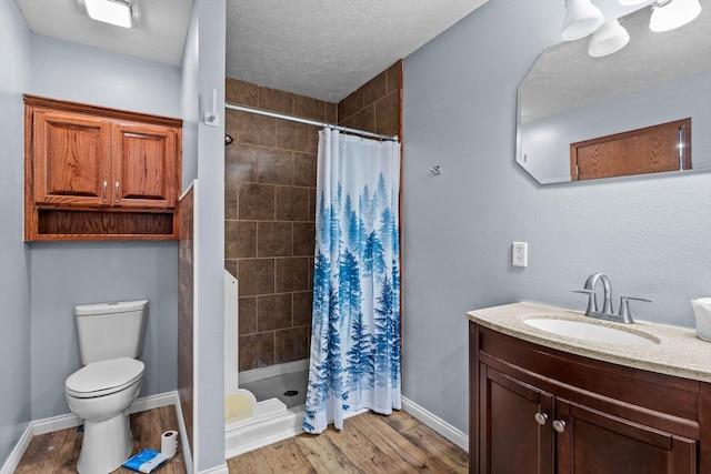 107 W Summit St, Aurora, MO 65605 - bathroom featuring vanity, wood finished floors, a shower stall, and a textured ceiling
