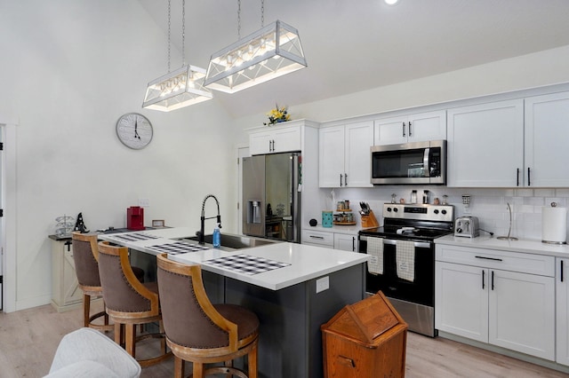 4360 State Highway Ww, Verona, MO 65769 - kitchen with stainless steel appliances, light wood-style flooring, a kitchen island with sink, light countertops, and high vaulted ceiling