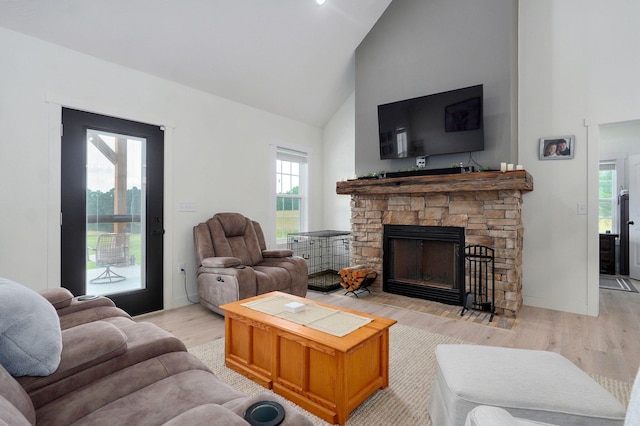 4360 State Highway Ww, Verona, MO 65769 - living room featuring high vaulted ceiling, light wood-style floors, a stone fireplace, and healthy amount of natural light
