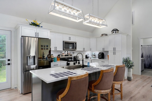 4360 State Highway Ww, Verona, MO 65769 - kitchen with appliances with stainless steel finishes, high vaulted ceiling, light wood-style floors, light countertops, and a kitchen island with sink
