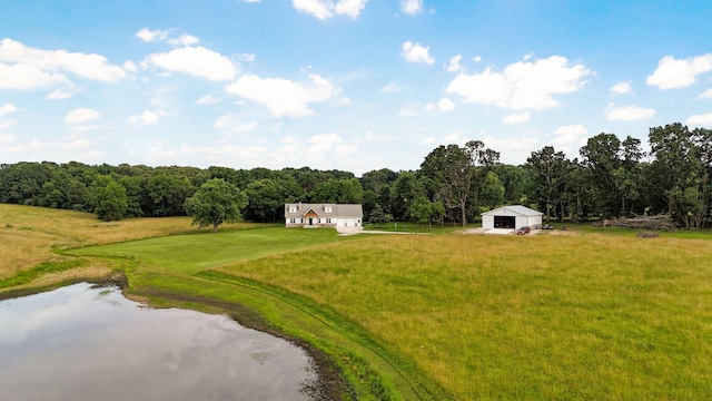 4360 State Highway Ww, Verona, MO 65769 - view of grassy yard with a garage, a water view, an outdoor structure, an outbuilding, and a view of trees