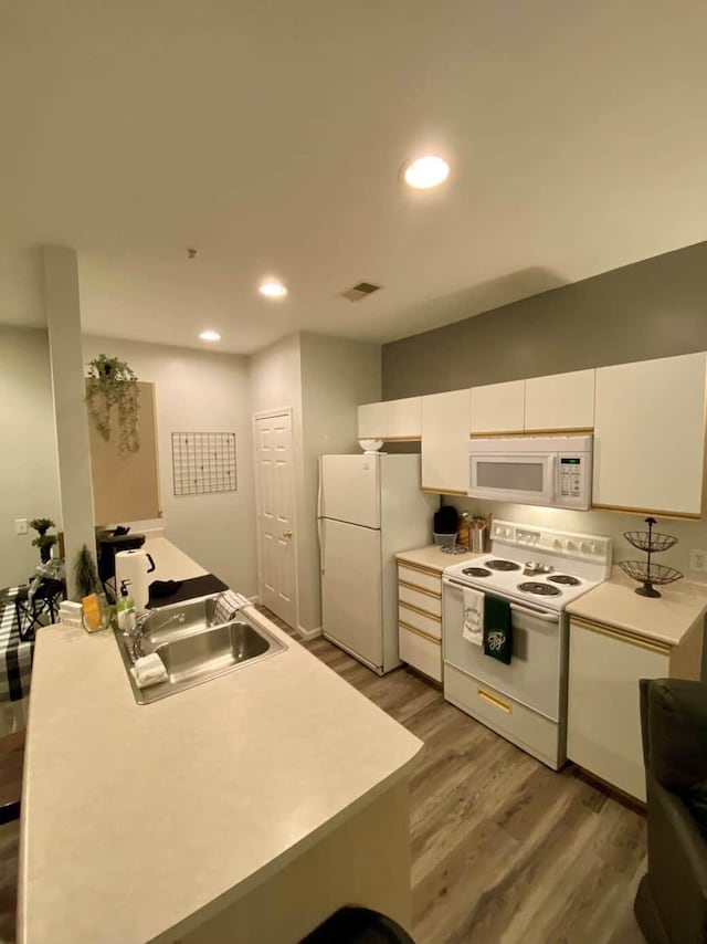 835 Fairview St Unit 3, Branson, MO 65616 - kitchen with white appliances, light wood finished floors, white cabinets, recessed lighting, and light countertops