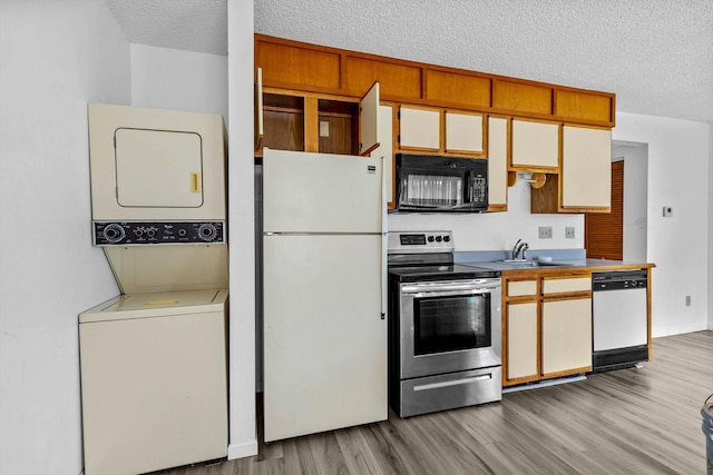 1 Memory Ln Unit 1, Branson, MO 65616 - kitchen with white appliances, stacked washer and clothes dryer, light wood finished floors, and a textured ceiling