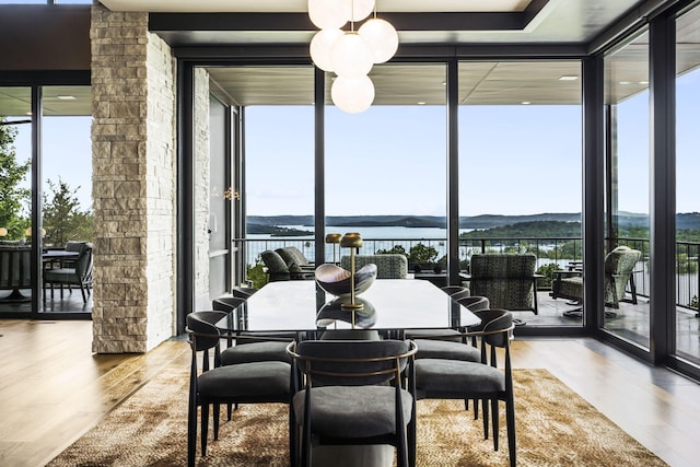 355 Catalina Dr, Branson, MO 65616 - dining space with expansive windows, plenty of natural light, wood finished floors, and a water and mountain view