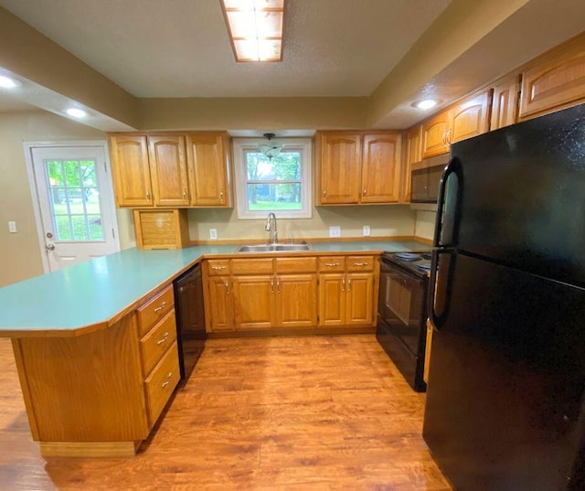 106 Cooley Dr, Carl Junction, MO 64834 - kitchen with black appliances, a peninsula, light wood-type flooring, plenty of natural light, and recessed lighting