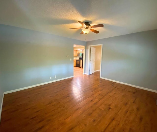 106 Cooley Dr, Carl Junction, MO 64834 - unfurnished room with ceiling fan, wood finished floors, and a textured ceiling