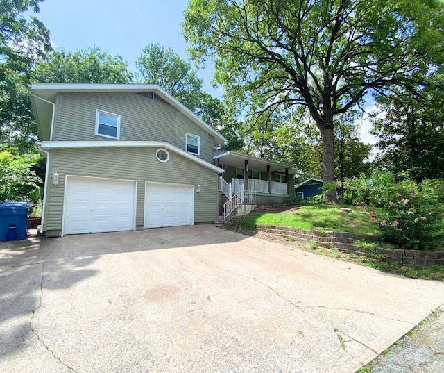 106 Cooley Dr, Carl Junction, MO 64834 - view of front of house featuring a porch, a garage, driveway, and stairs