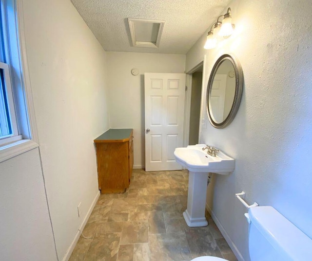 106 Cooley Dr, Carl Junction, MO 64834 - bathroom featuring a textured ceiling and stone finish floors