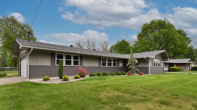 2823 E Catalpa St, Springfield, MO 65804 - ranch-style house with an attached garage, board and batten siding, and driveway