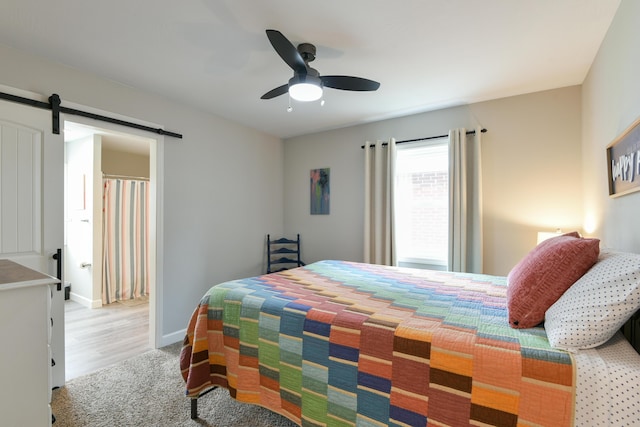 2823 E Catalpa St, Springfield, MO 65804 - bedroom with a barn door, carpet floors, and a ceiling fan