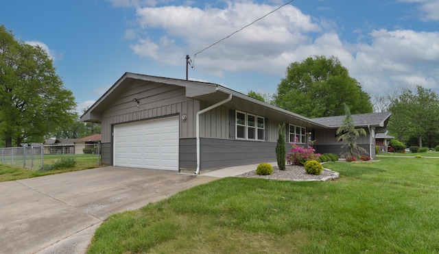 2823 E Catalpa St, Springfield, MO 65804 - ranch-style house with a garage, concrete driveway, and board and batten siding