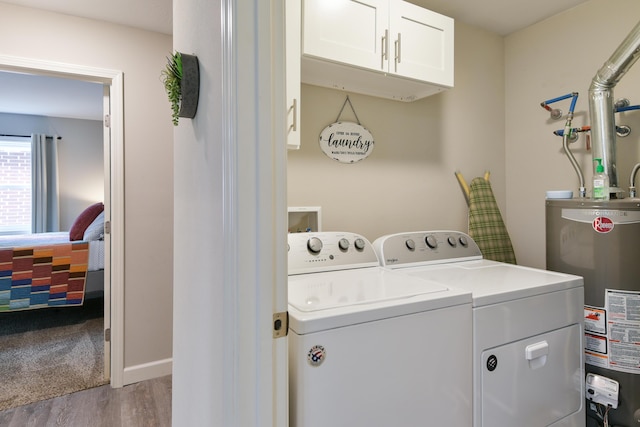 2823 E Catalpa St, Springfield, MO 65804 - laundry area with water heater, washer and clothes dryer, cabinet space, and wood finished floors