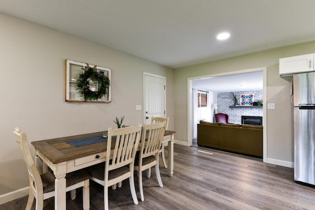 2823 E Catalpa St, Springfield, MO 65804 - dining room with a fireplace, wood finished floors, and recessed lighting