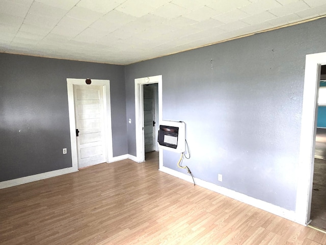 306 S Locust St, Buffalo, MO 65622 - spare room with heating unit and wood finished floors