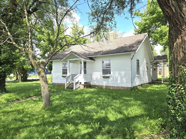 306 S Locust St, Buffalo, MO 65622 - view of front of property with a chimney, a front yard, and roof with shingles