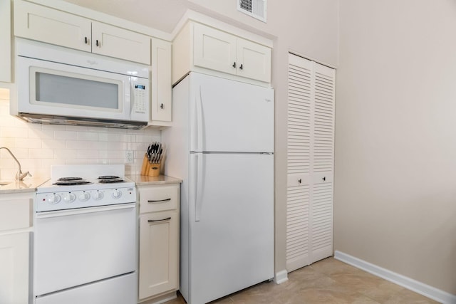 540 Abby Ln Unit 6, Branson, MO 65616 - kitchen featuring white appliances, light countertops, backsplash, and white cabinetry