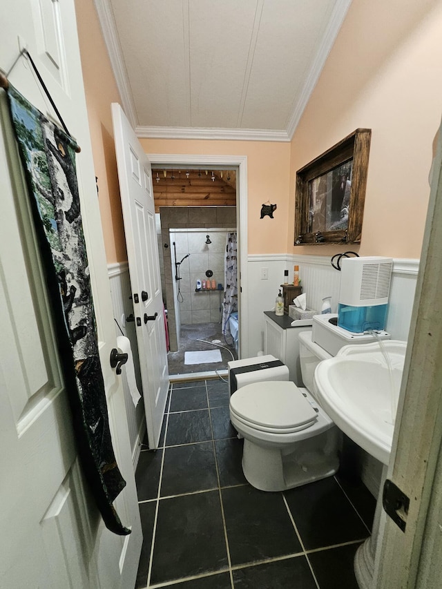 462 Jellystone Ave, Hollister, MO 65672 - bathroom with crown molding, a wainscoted wall, tiled shower, and tile patterned flooring