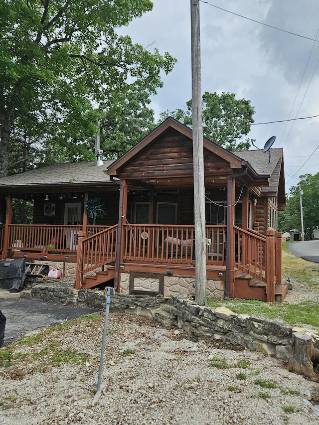 462 Jellystone Ave, Hollister, MO 65672 - view of front of house featuring covered porch and roof with shingles