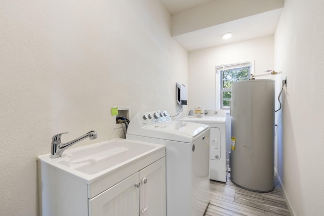 19899 E 1820th Rd, Fair Play, MO 65649 - laundry area with electric water heater, separate washer and dryer, cabinet space, and light wood-style flooring