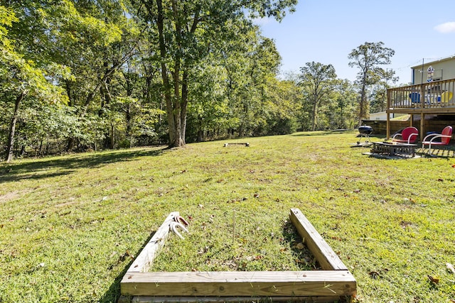 19899 E 1820th Rd, Fair Play, MO 65649 - view of green lawn with a fire pit and a wooden deck