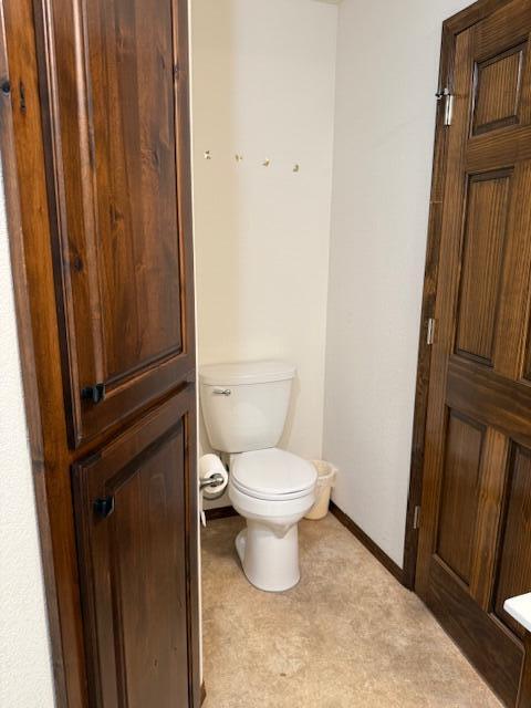 2604 Country Dr, Mountain Grove, MO 65711 - bathroom with toilet and baseboards